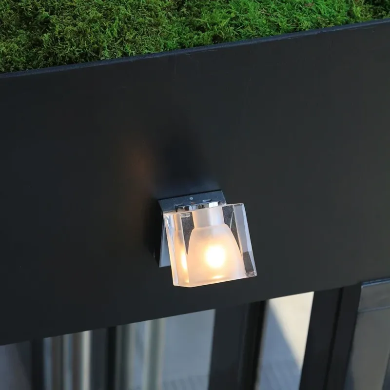 Fabbian Cubetto Wandstrahler GU10 an einer Wand montiert, mit transparentem Diffusor und dekorativem Lichteffekt.