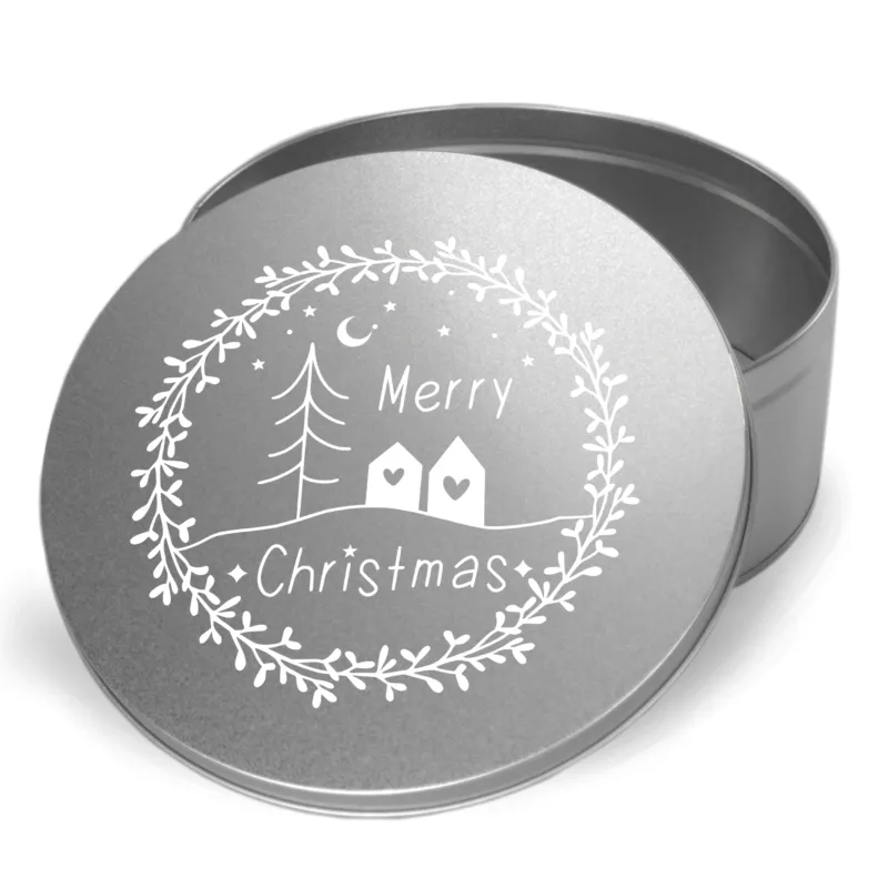 Silberne Geschenkdose mit Weihnachtsmotiv und Schriftzug.