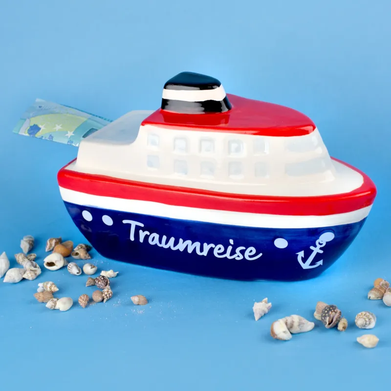 Spardose Schiff Traumreise mit rotem, blauem und weißem Design, seitlich mit Geldschein