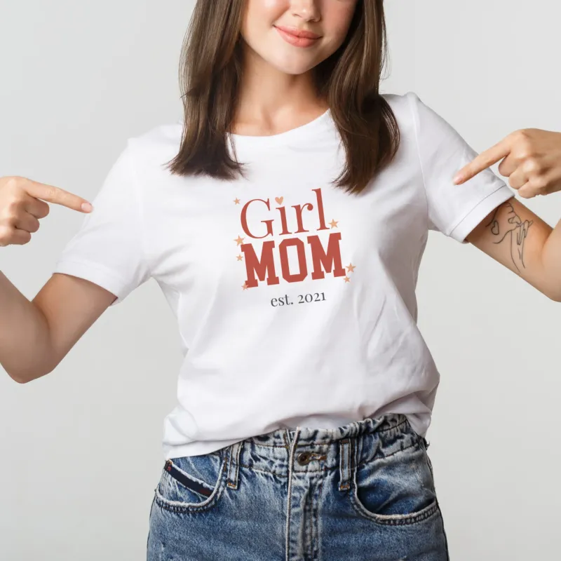 Frau trägt weißes „Girl Mom“ T-Shirt und zeigt auf den personalisierten Aufdruck